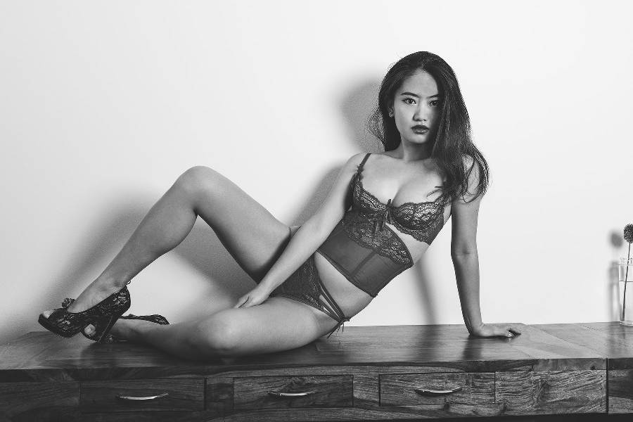 Model in axami lingerie posing on furniture