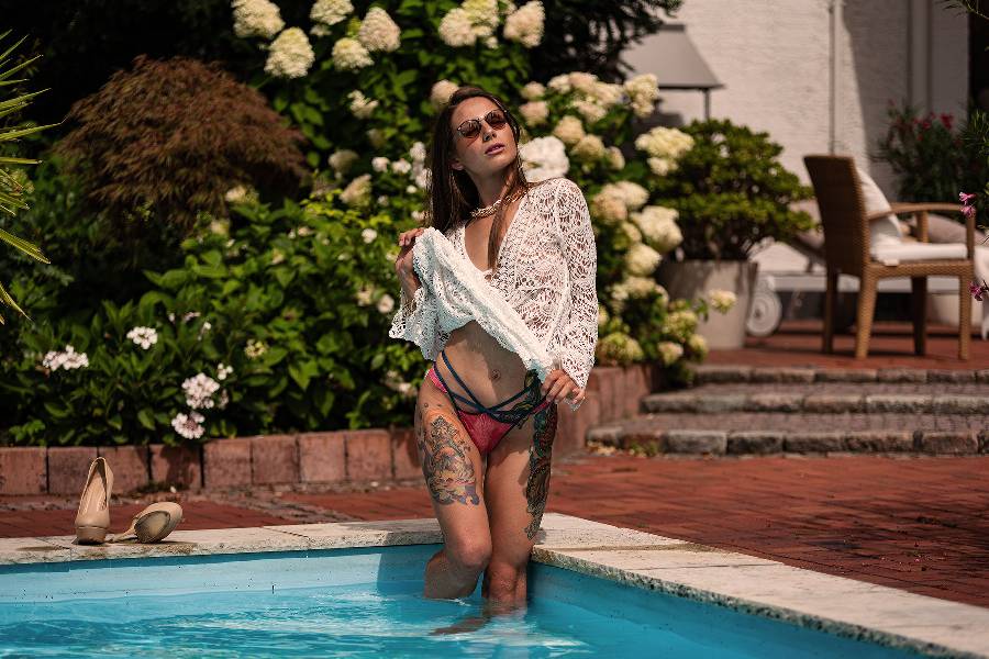 Model at the pool wearing sunglasses