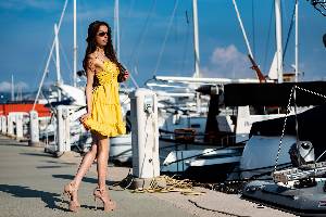 Model simi posing in cute fashion and high heels at mallorca modelfinca harbor